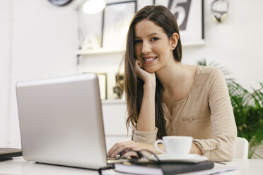 Young female entrepreneur with laptop at home office - EBSF000435