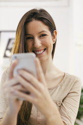 Portrait of young female entrepreneur with smartphone - EBSF000437