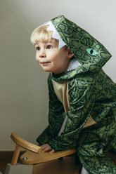 Portrait of little boy wearing dinosaur costume at home - MFF001485