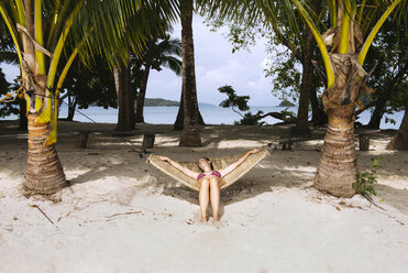 Philippines, Palawan, Woman relaxing on beach hammock - GEMF000047