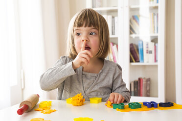 Little girl playing with yellow modeling clay - LVF002853