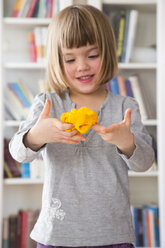 Little girl with yellow modeling clay - LVF002843