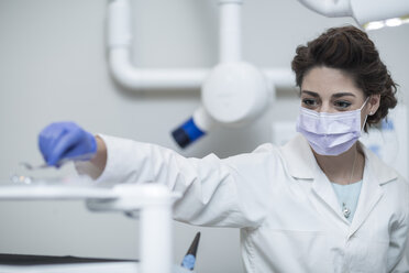 Female dentist examining patient with mouth mirror - ZEF003889