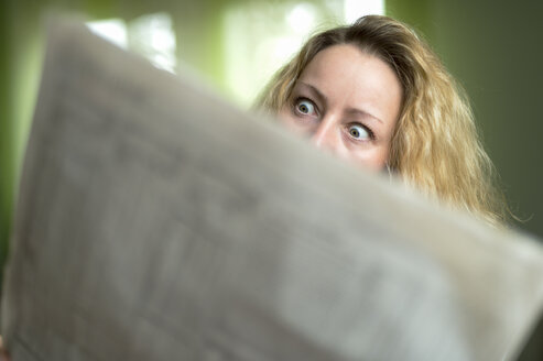 Verängstigte Frau liest Zeitung - FRF000199