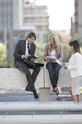 Businesspeople having a meeting outdoors - ZEF004496