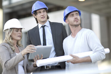 Team of architects having meeting at construction site - ZEF004499