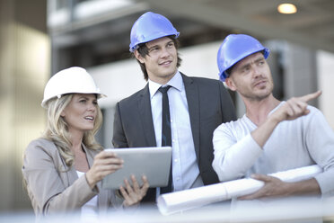 Team of architects having meeting at construction site - ZEF004500