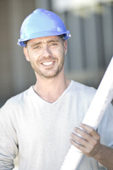 Foreman with construction plan on site - ZEF004503