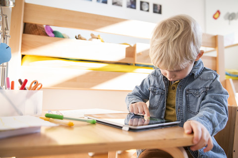 Little boy drawing with digital tablet stock photo