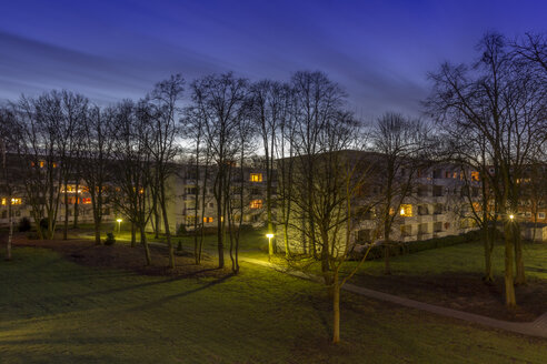 Germany, Bremen, Moving clouds over an apartment block in the evening - NK000232