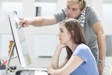 Creative office people discussing work on a computer - ZEF002984