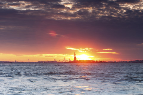 USA, New York, New York City, Manhattan, Statue of Liberty at sunset stock photo