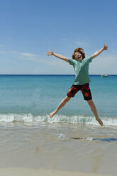 France, Corsica, Favone, boy having fun at a beach - LBF001065