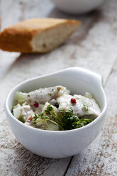 Bowl of pickled herring salad with cress - CSF024604