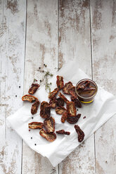 Dried tomatoes and glass of pickled dried tomatoes - CSF024630