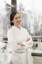 Young scientist standing in laboratory with arms crossed - FKF000919