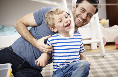 Vater und Sohn spielen zusammen im Kinderzimmer - RHF000608