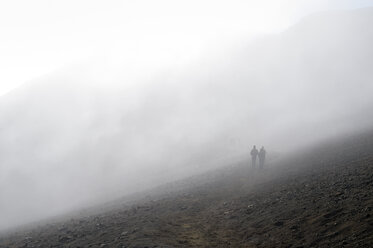 USA, Hawaii, Maui, Haleakala, hikers in fog inside the volcanic crater - BRF001045