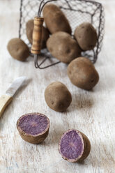 Sliced and whole raw Blue Congo potatoes - EVGF001272