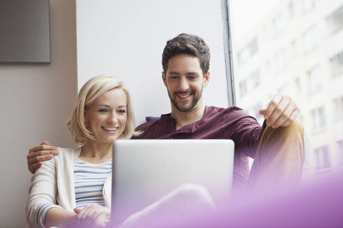 Couple watching something on laptop - RBF002460