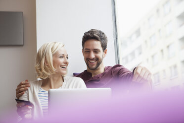 Happy couple using digital tablet for online shopping - RBF002461