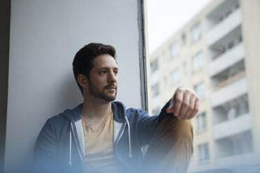 Portrait of man looking through window - RBF002477