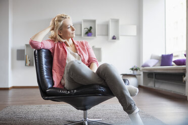 https://us.images.westend61.de/0000532093j/woman-relaxing-on-leather-chair-at-home-RBF002487.jpg