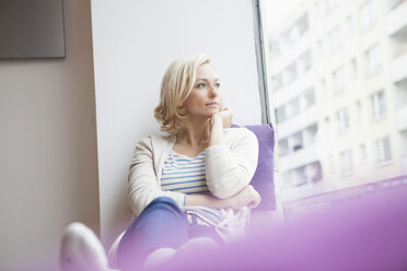 Portrait of woman looking through window - RBF002513