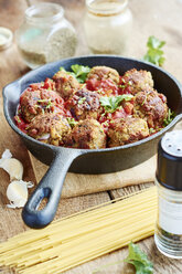 Vegan meatless balls in tomato sauce in a cast iron pan - HAWF000673