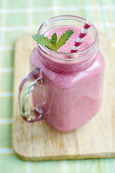 Glass of berry banana smoothie - HAWF000689