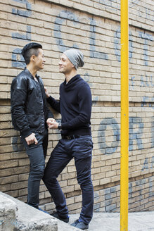 China, Hong Kong, gay couple at house wall - JUBF000007