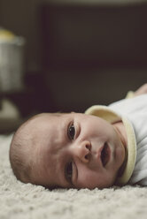 Portrait of baby boy lying on blanket - RAEF000057