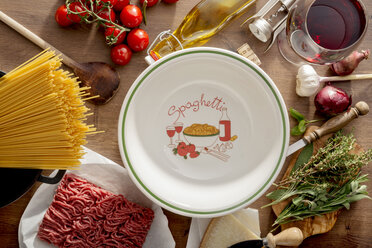 Italian Food, ingredients for Spaghetti Bolognese and plate on wood - CSTF000885