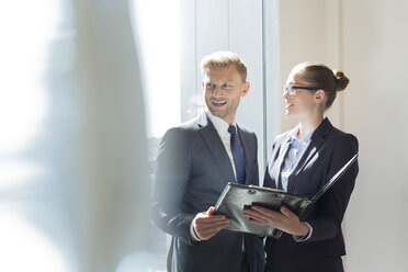 Businessman and businesswoman preparing for meeting - WESTF020855