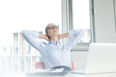 Businesswoman sitting at desk, day dreaming - WESTF020896