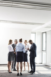 Business people standing in circle, talking - WESTF021020