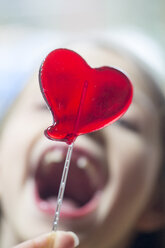 Girl's open mouth and heart-shaped lollipop - SARF001432