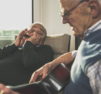 Two senior men making music together - UUF003462