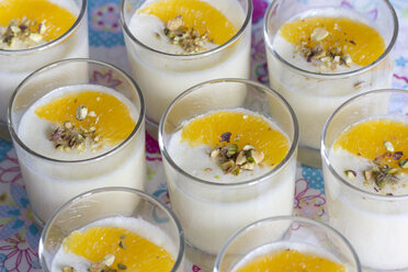 Dessert from milk, semolina and orange juice in glasses, garnished with orange filets - YFF000324