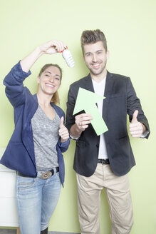 Two colleagues with energy-saving lamp - PATF000036