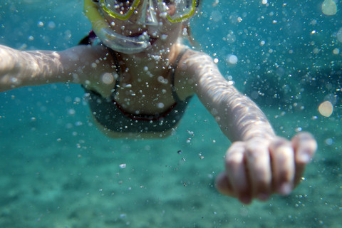 Europe, Girl snorkeling in sea stock photo