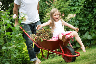 Little girl sitting on a wheelbarrow - WESTF021168