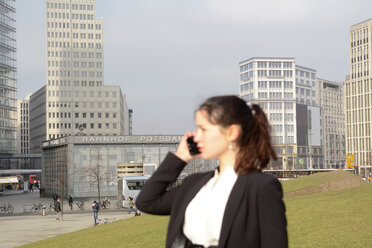 Germany, Berlin, Potsdamer Platz, businesswoman on smartphone - BFRF000948