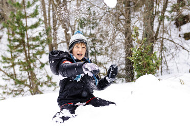 Happy boy playing with snow in the woods - GEMF000079