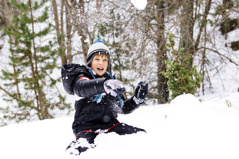 Glücklicher Junge spielt mit Schnee im Wald - GEMF000079