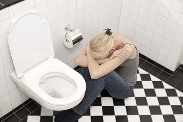 Poster of a woman skeleton sitting on toilet reading newspaper on door of  women's bathroom. Rush City Minnesota MN USA Stock Photo - Alamy