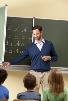 Teacher at blackboard with variations of letter A - MFRF000085