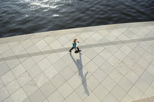 Young woman walking at waterfront promenade - BFRF000990