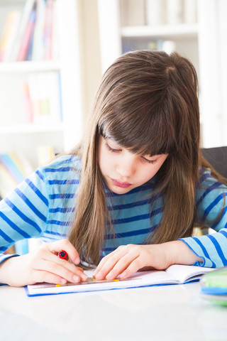 Girl doing homework stock photo