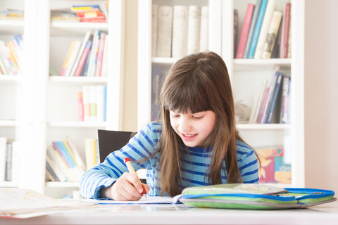 Girl doing homework stock photo